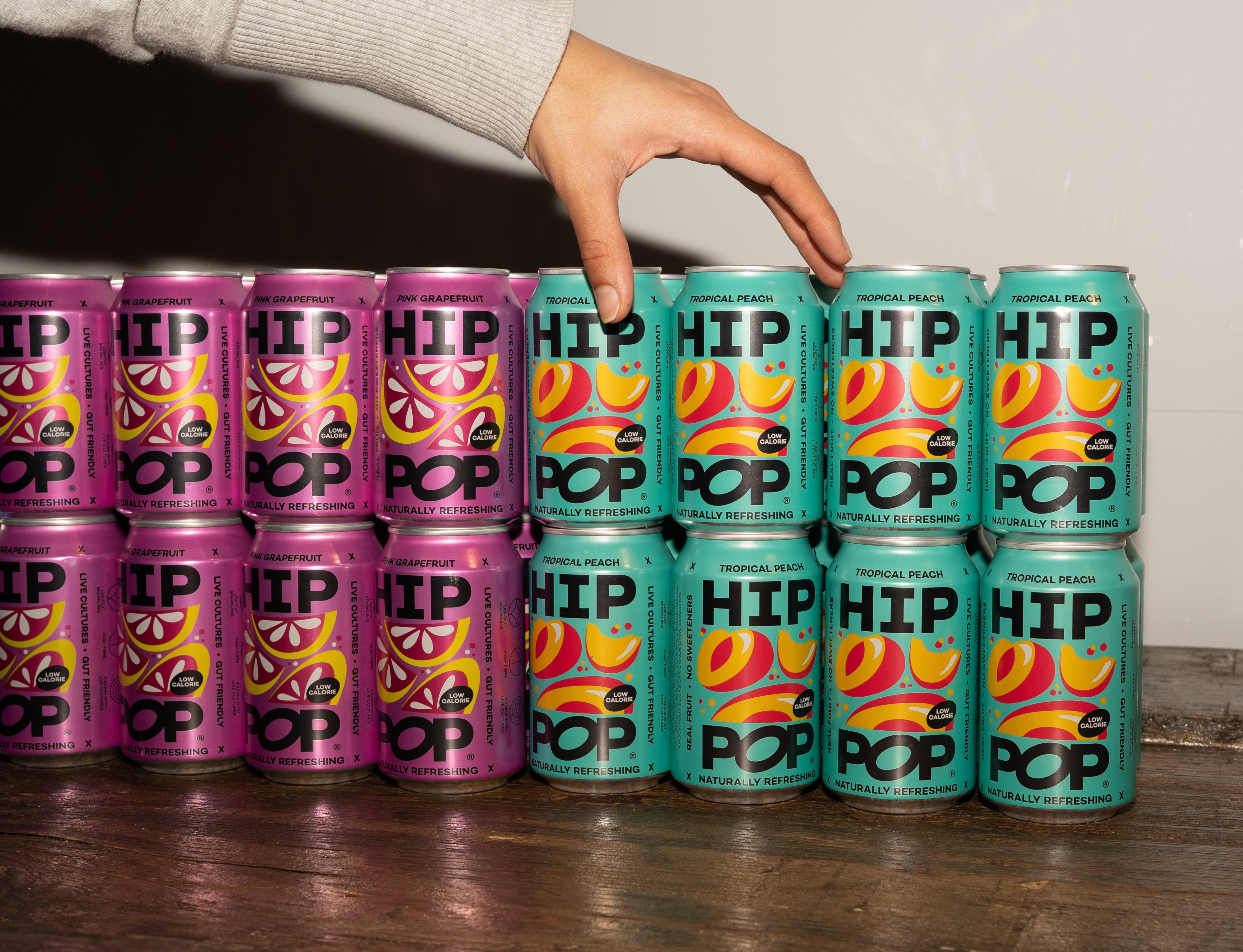 A colourful display of HIP POP cans, each can contains 5g of fibre and is a naturally refreshing beverage.