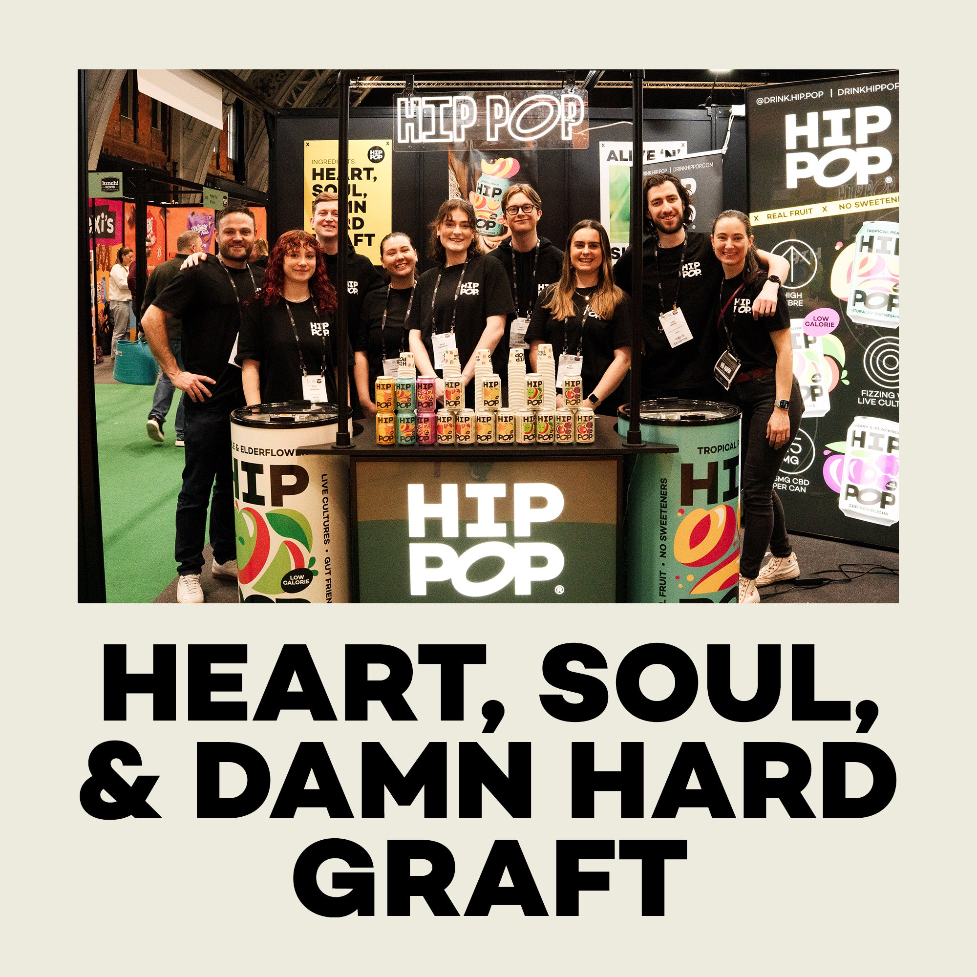 Hip Pop team standing behind a 'HIP POP' branded counter with products on display.