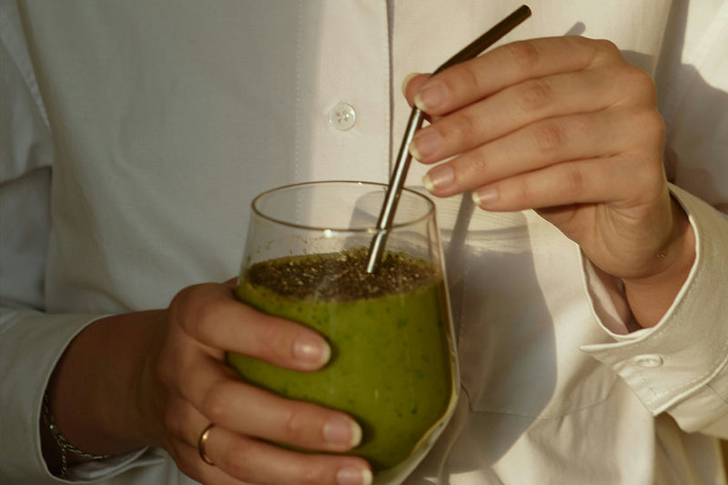 woman holding a glass of smoothie