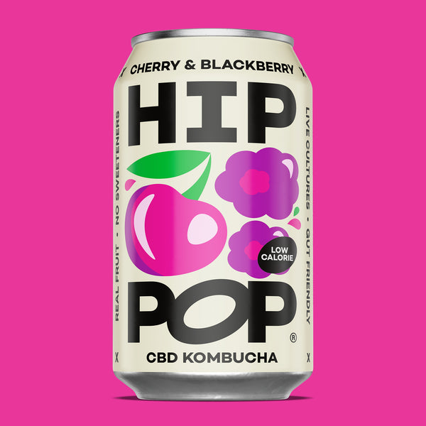 Can of Cherry & Blackberry HIP POP CBD Kombucha on a pink background