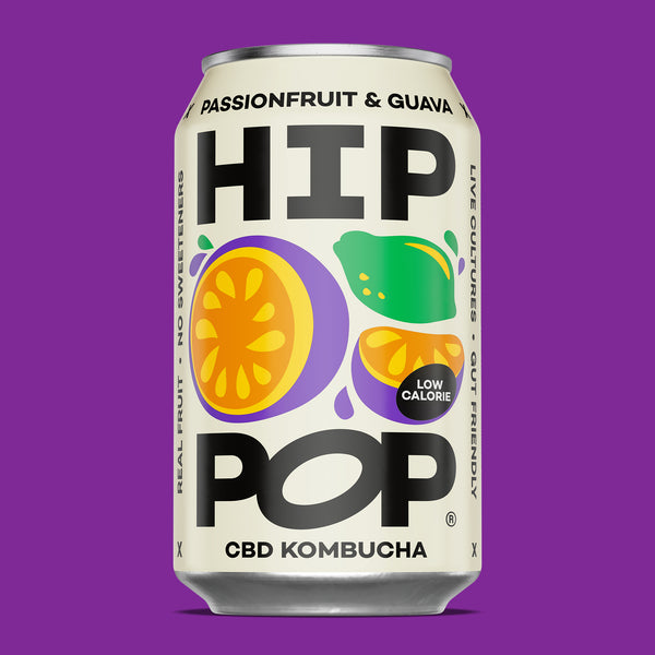 Can of HIP POP CBD Kombucha with colorful fruit graphics on a purple background