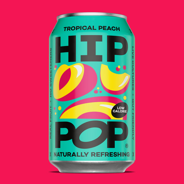 Can of HIP POP Tropical Peach drink on a pink background